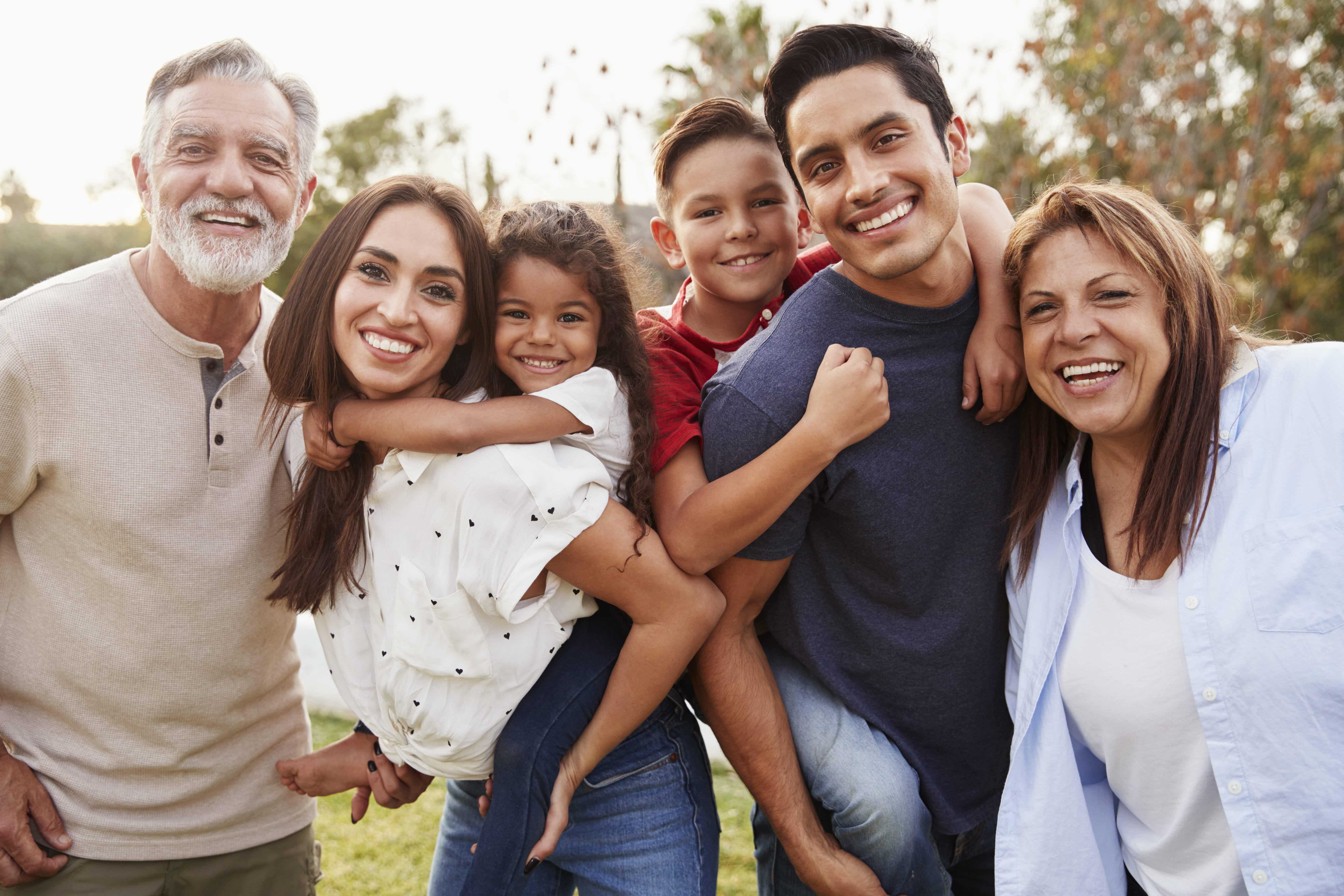 Group of diverse family smiling together outside