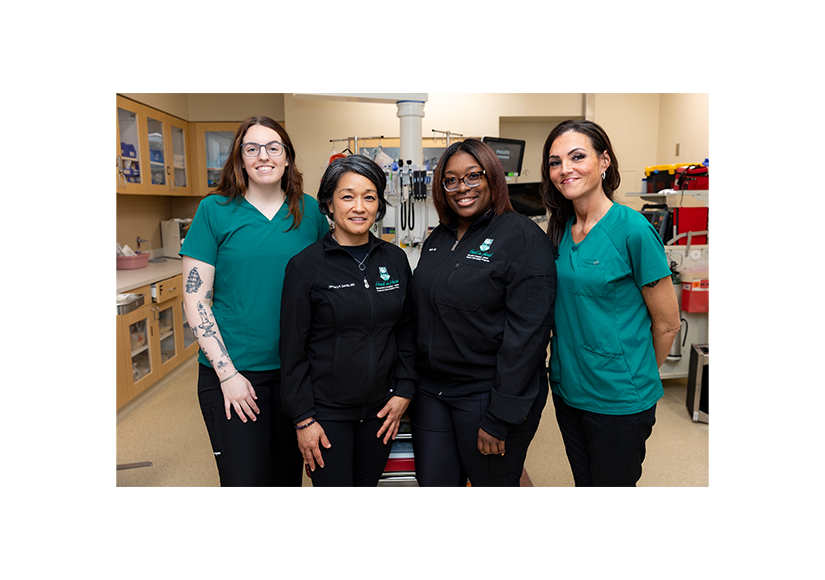Group of diverse women standing in a line in a emergency room smiling 