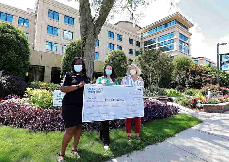 Three women holding a check