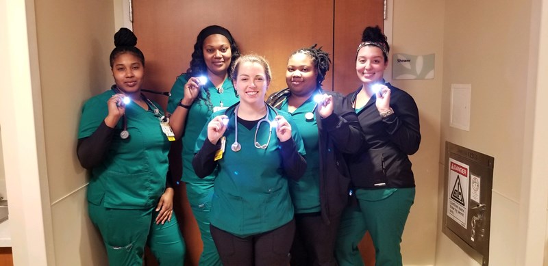 Hospital staff showing off newly donated hug lights