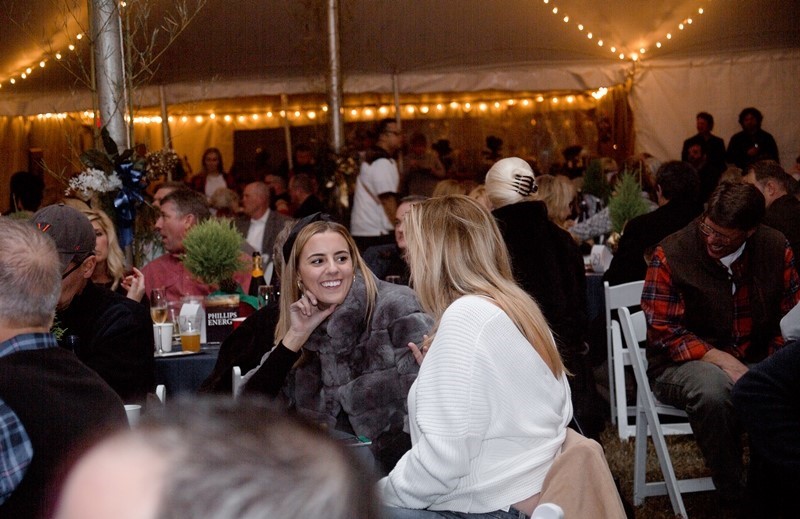 two ladies sitting at a table talking
