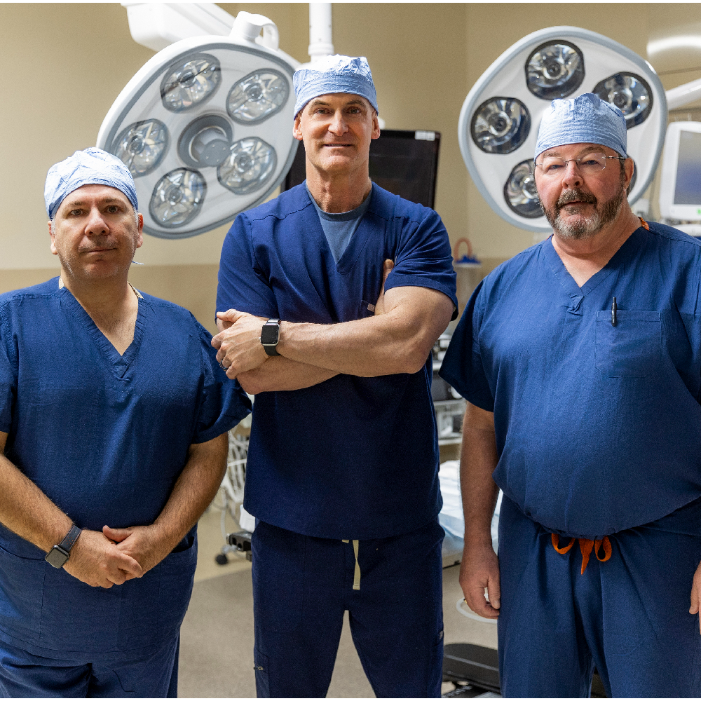 Cardiothoracic surgery team standing in an operating room at Riverside Health, representing advanced heart and lung surgery, surgical expertise, collaborative care, and the Riverside Health–UVA Health affiliation.