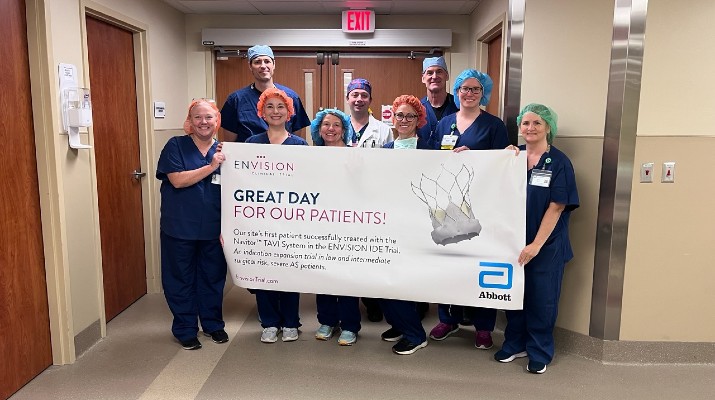 Riverside Health and UVA Health clinical team members holding a banner recognizing excellence in patient care, representing healthcare collaboration, quality outcomes, team-based care, and the Riverside Health–UVA Health affiliation.
