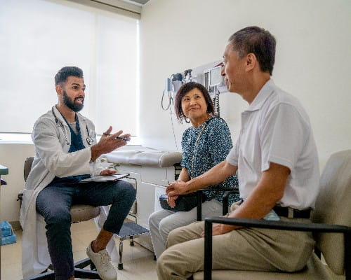 Healthcare provider meeting with patients during a transplant outreach clinic consultation at Riverside Health, representing transplant evaluation, specialty care access, patient education, and the Riverside Health–UVA Health affiliation.