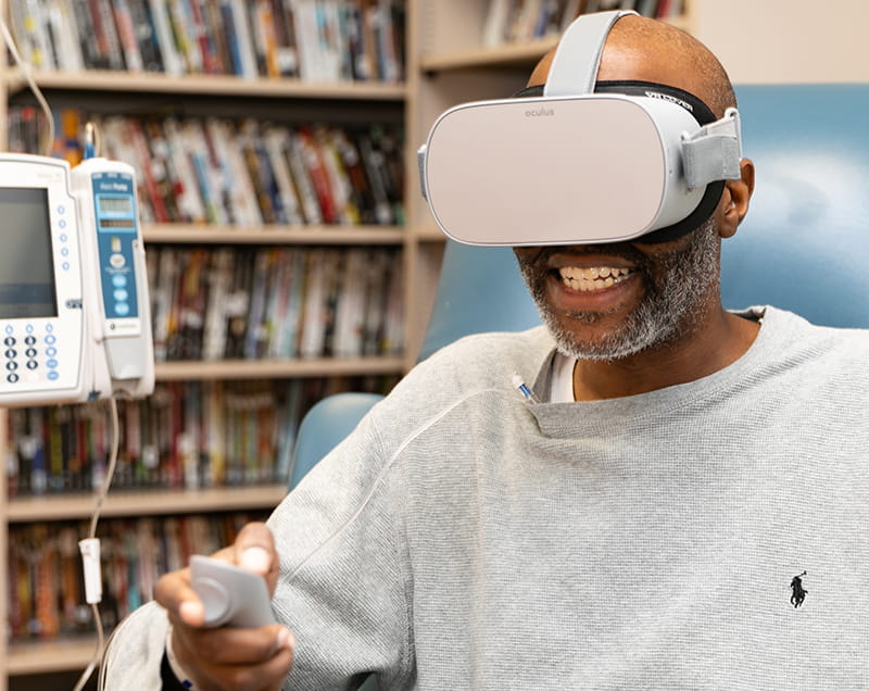 Charles Frierson using virtual reality goggles during cancer treatment