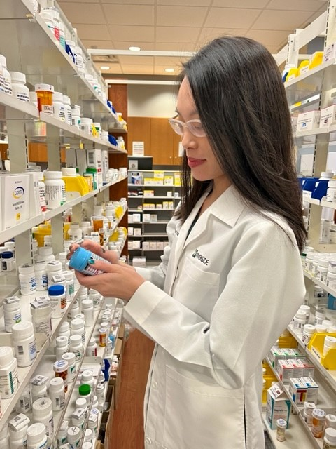 a photo of Waimin checking a prescription bottle
