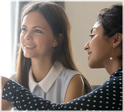 two young adult female students working together