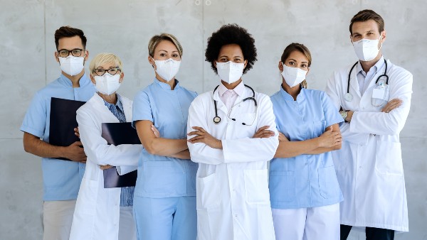 Team of confident medical experts with protective face masks