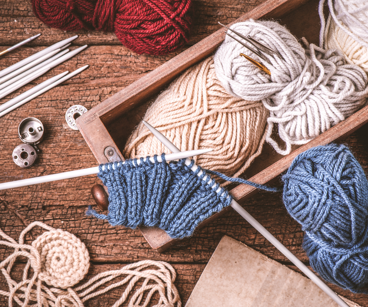Box of yarn and knitting needles