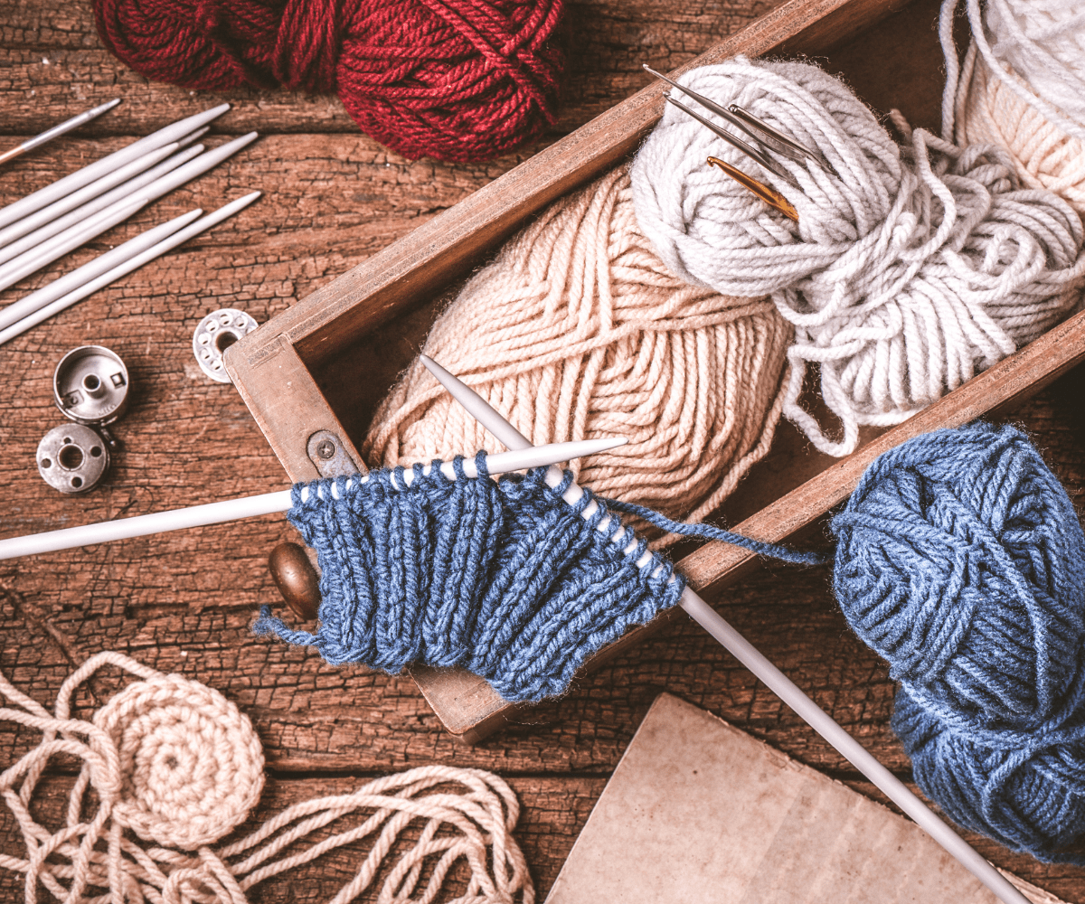 Box of yarn and knitting needles