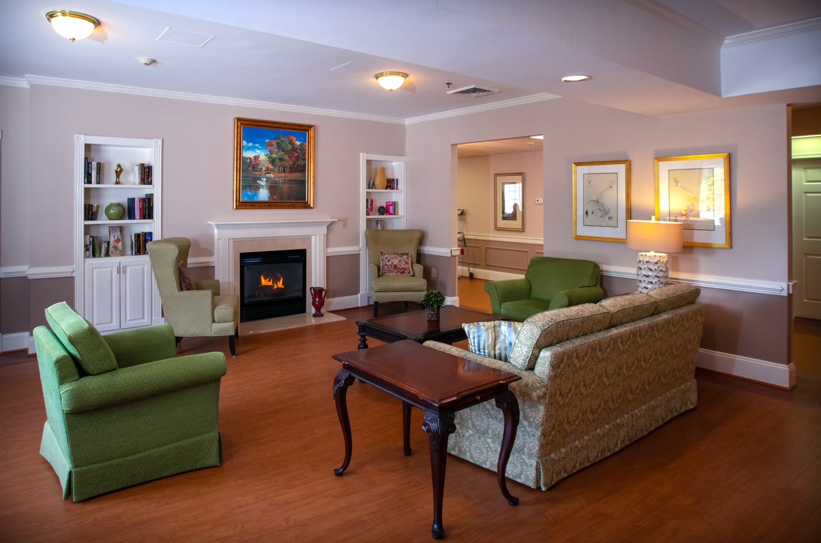 photo of an interior of a house with a green chair to the left and a grey couch