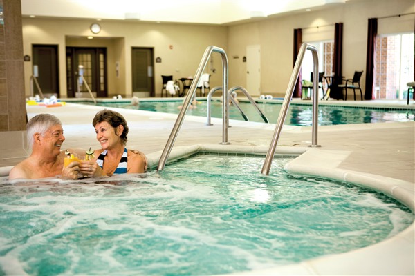 Elderly couple relax in the jacuzzi