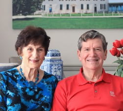 older white woman in blue shirt sitting next to husband in red shirt