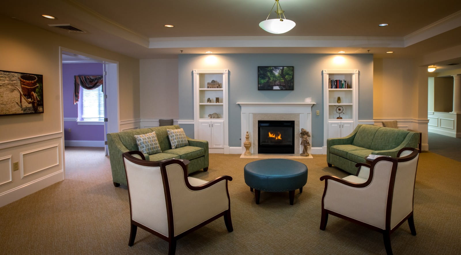 image of a sitting room with grey chairs and a white fireplace
