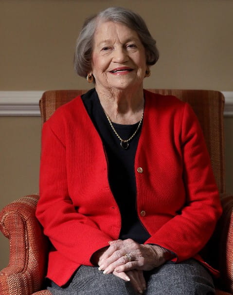 older senior woman smiling in a black shirt