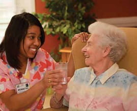 Nurse with her resident at The Gardens