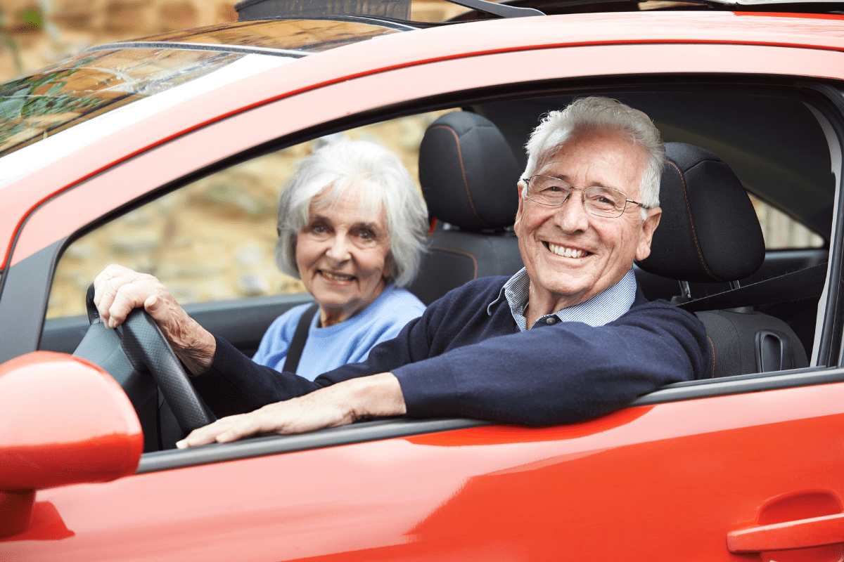 Smiling Senior Couple Out For Drive In Car