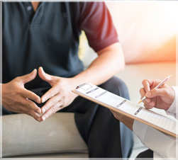 Man sitting while being evaluated