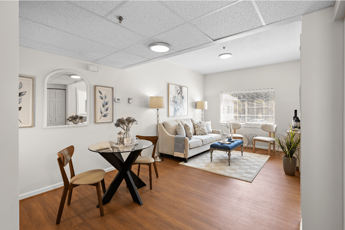 Comfortable senior living apartment featuring a private living area with dining space, natural light, modern furnishings and a welcoming residential environment designed for independent living and assisted living residents.