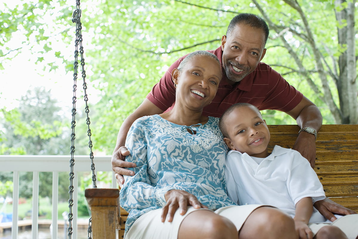 Smiling grandparents with their grandson.