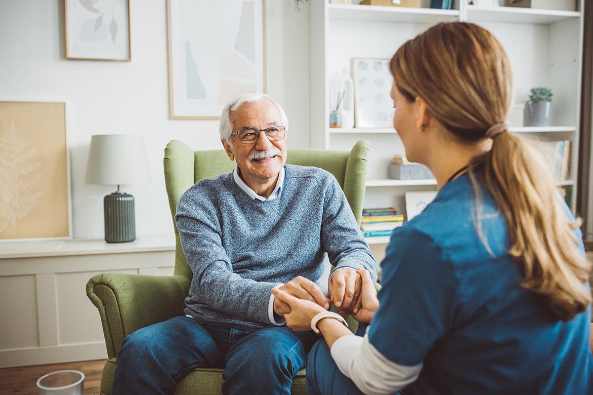 Nurse visiting elderly patient at home.