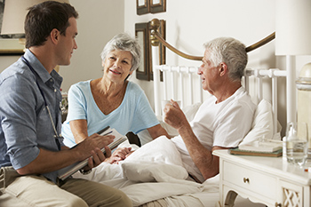 Doctor with patients in their home