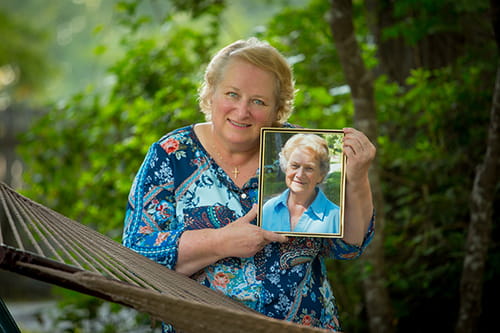 Kathy Helbig with portrait of mom