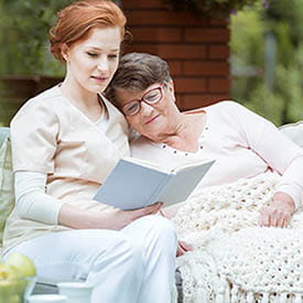 Nurse reading to hospice resident