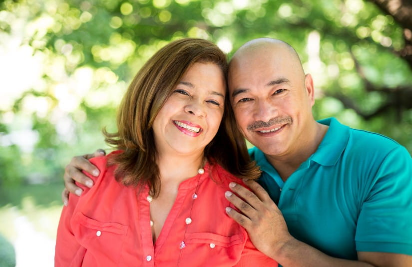 Smiling couple outdoors during a cancer survivorship journey, representing compassionate cancer treatment, emotional support, recovery, wellness, and comprehensive oncology care at Riverside Health.