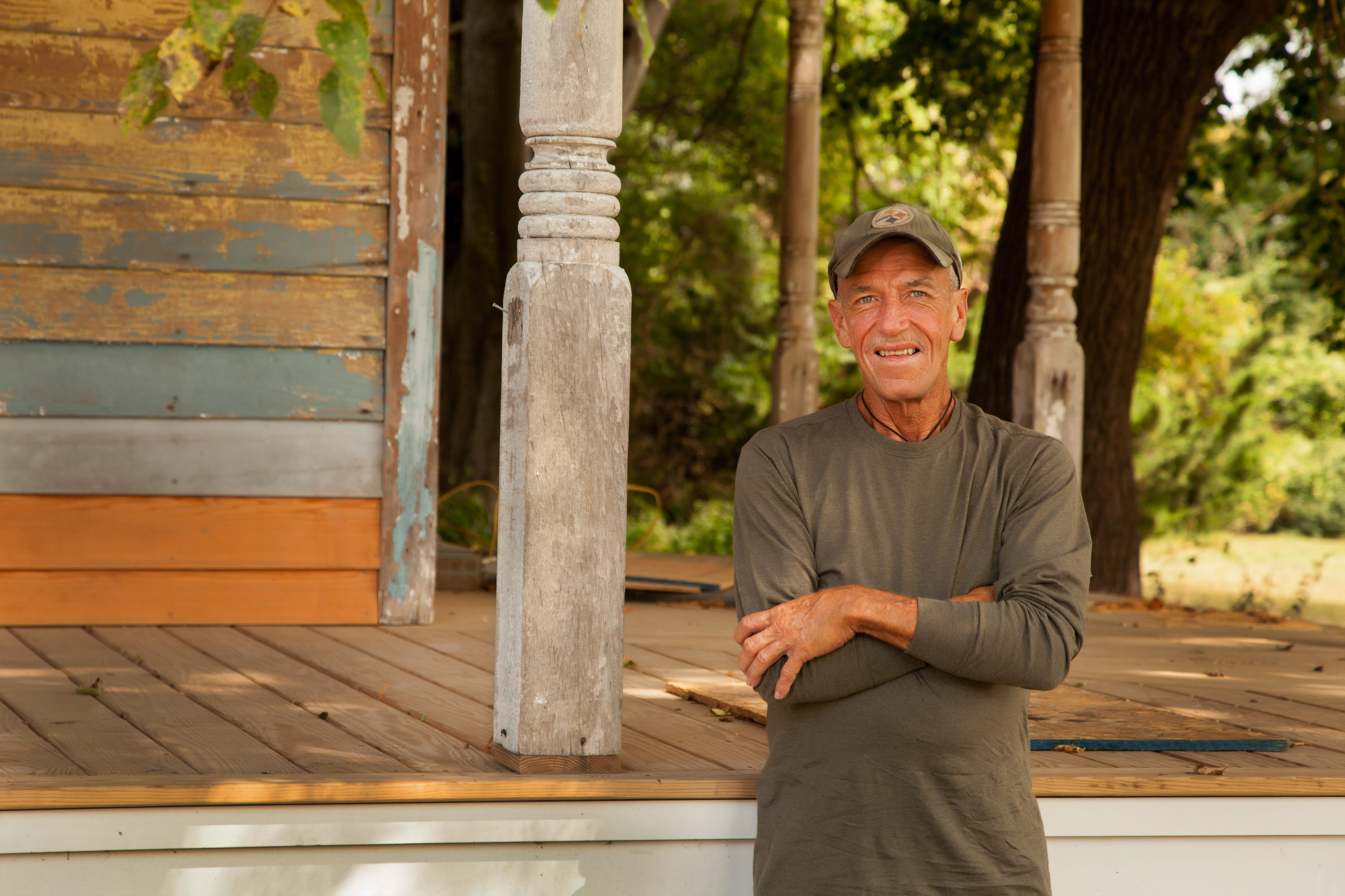 Walt Bennet in front of a porch being renovated