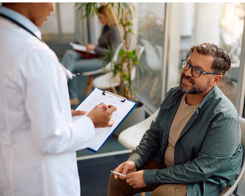 Happy man talking to his doctor at medical clinic