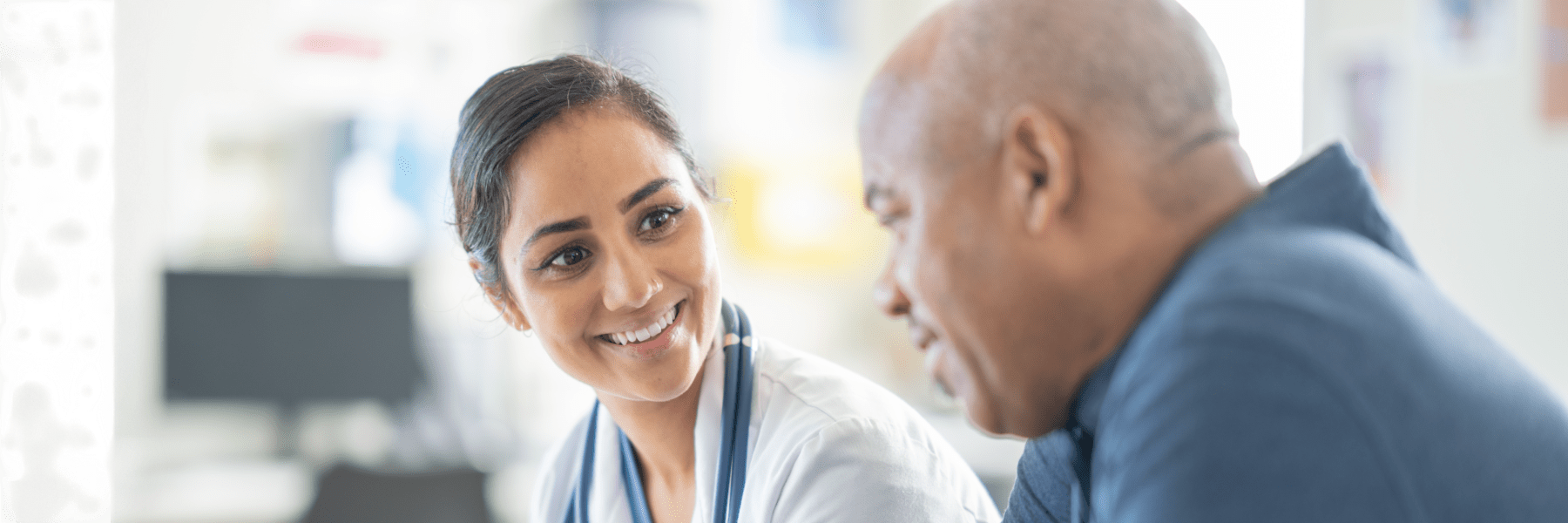 Healthcare professional consulting with a patient during a medical appointment in a clinical setting