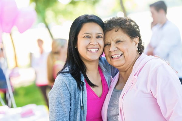 adult daughter with her mother wearing pink