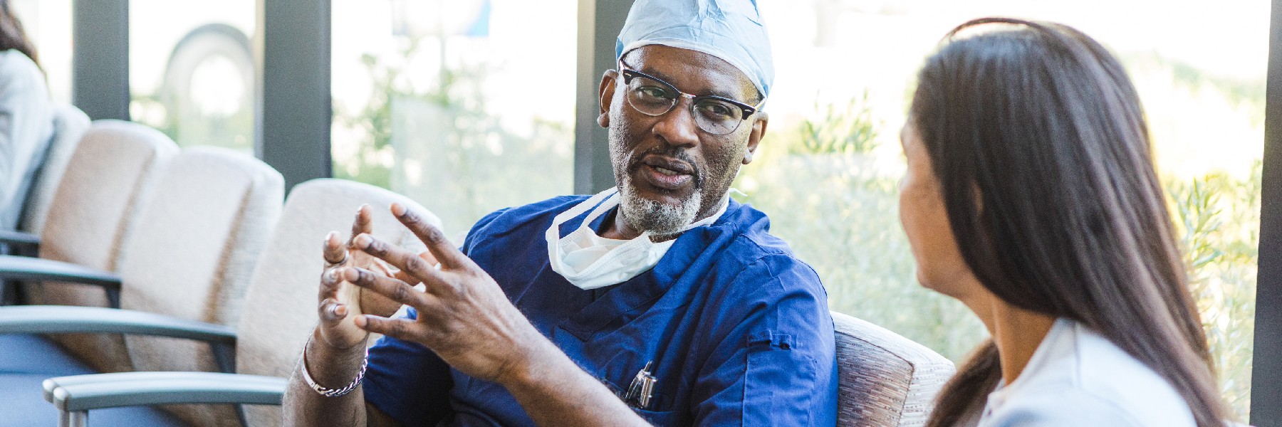 Doctor talks to young adult female 