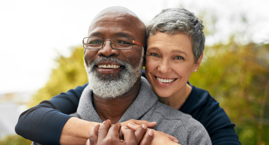 older woman and older man hugging