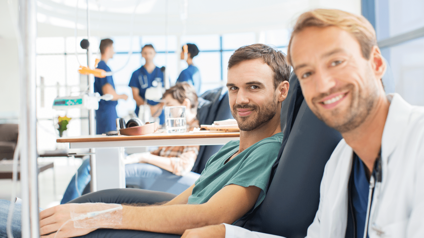 Portrait of smiling doctor and patient undergoing medical treatment in outpatient clinic 