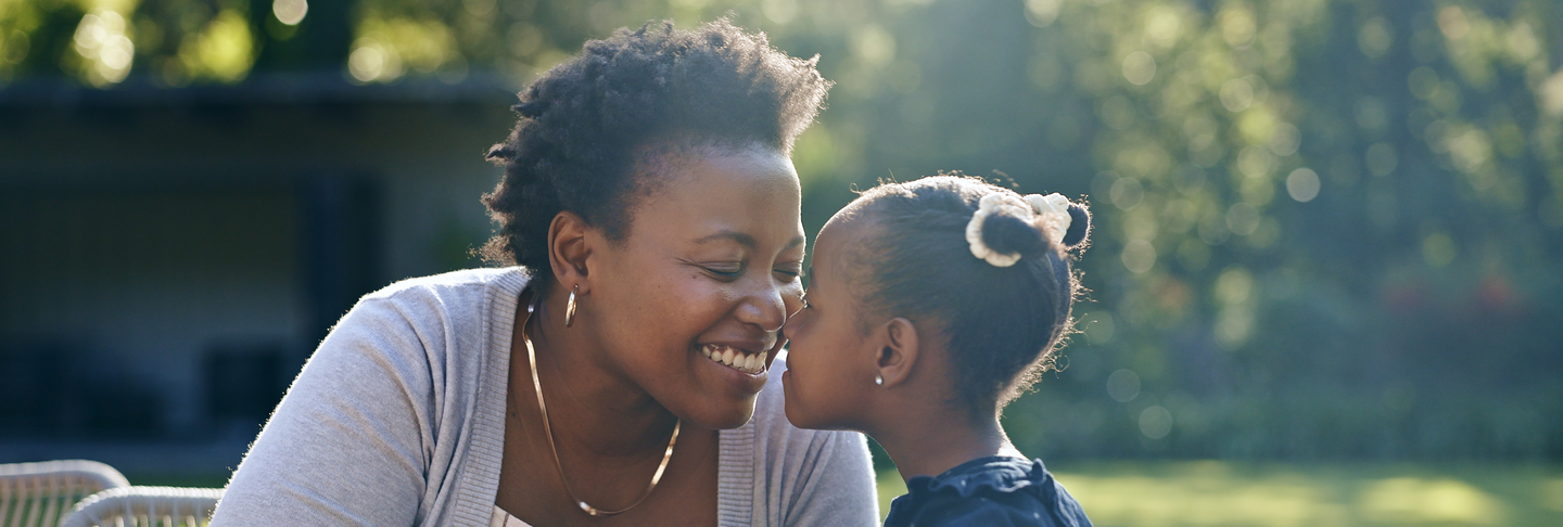 Mother, daughter and nose touch in nature for birthday, garden party and happy celebration in summer. Black people, woman or child with love bonding in smile, cake or smile together in outdoor park