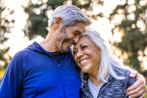 A senior couple walking outside and staying healthy