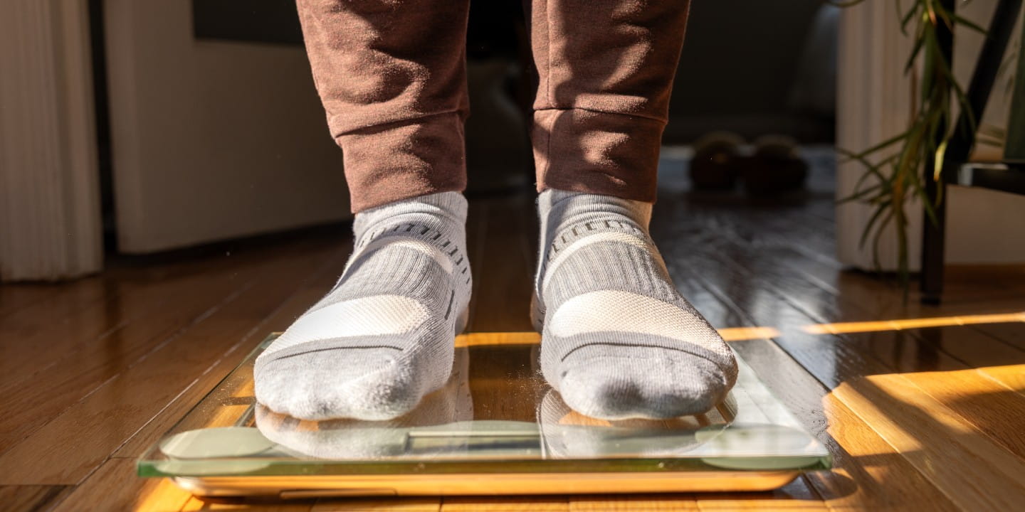 Male Stepping on Floor Scale - Weight Loss
