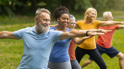 Group of diverse seniors led by instructor 