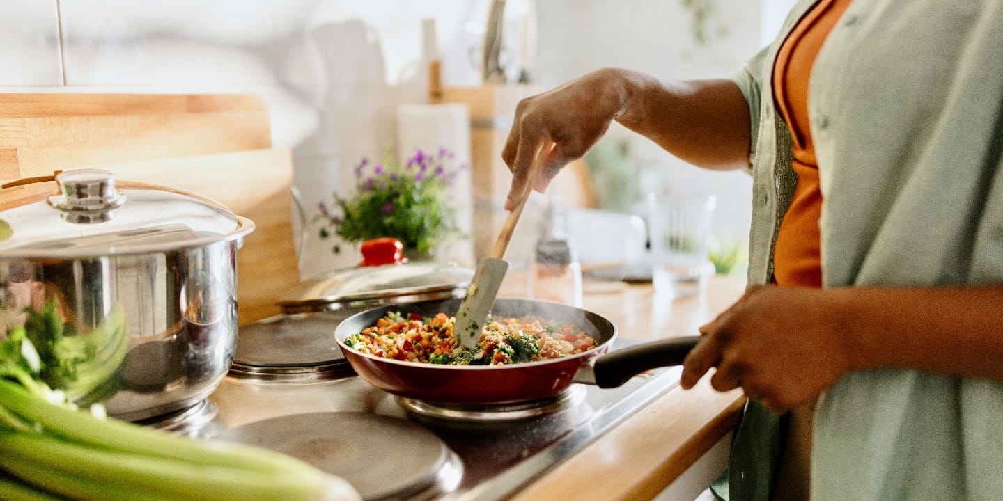 Woman preparing quinoa vegetable mix cooked