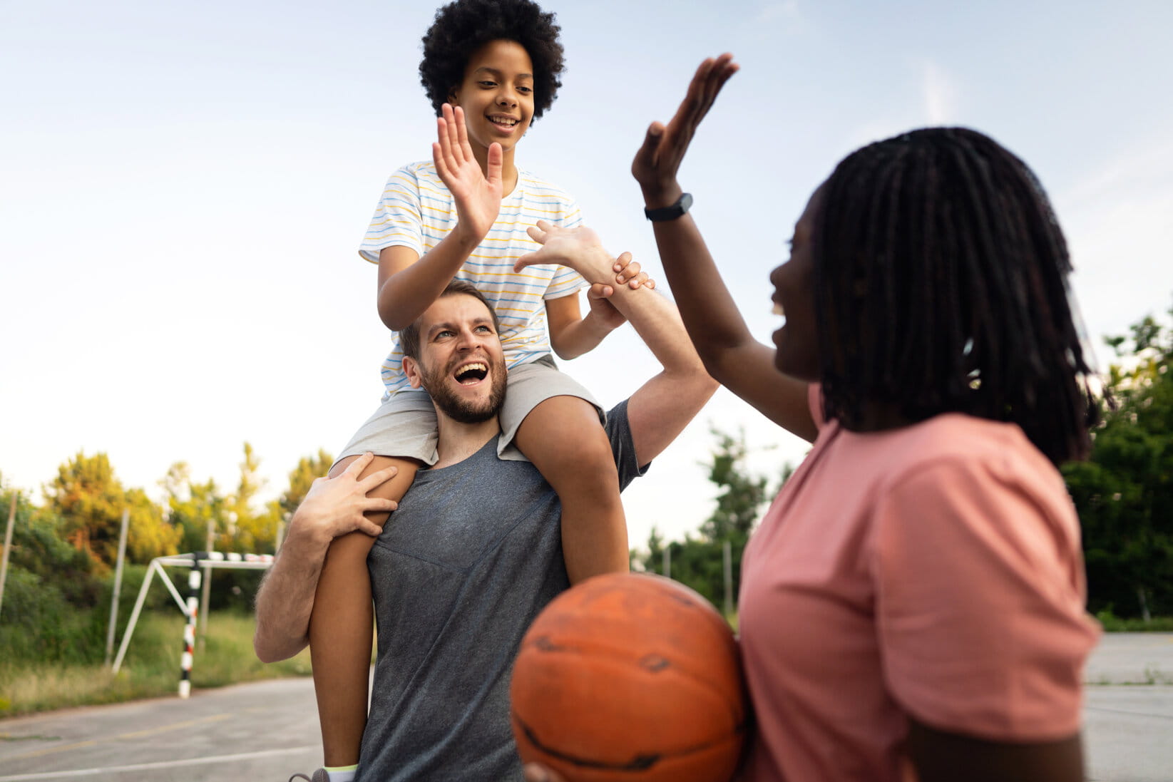 High-five interchange between multiracial blended family,