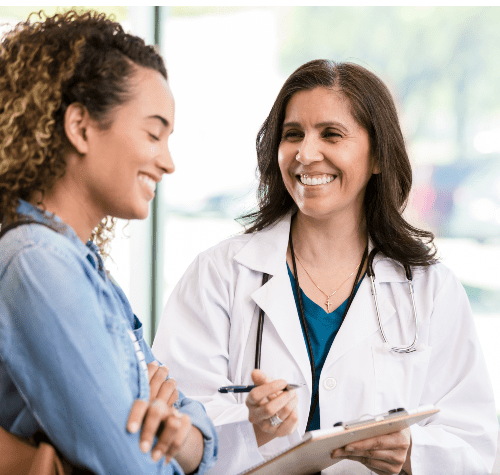 Cheerful female patient talks with female doctor