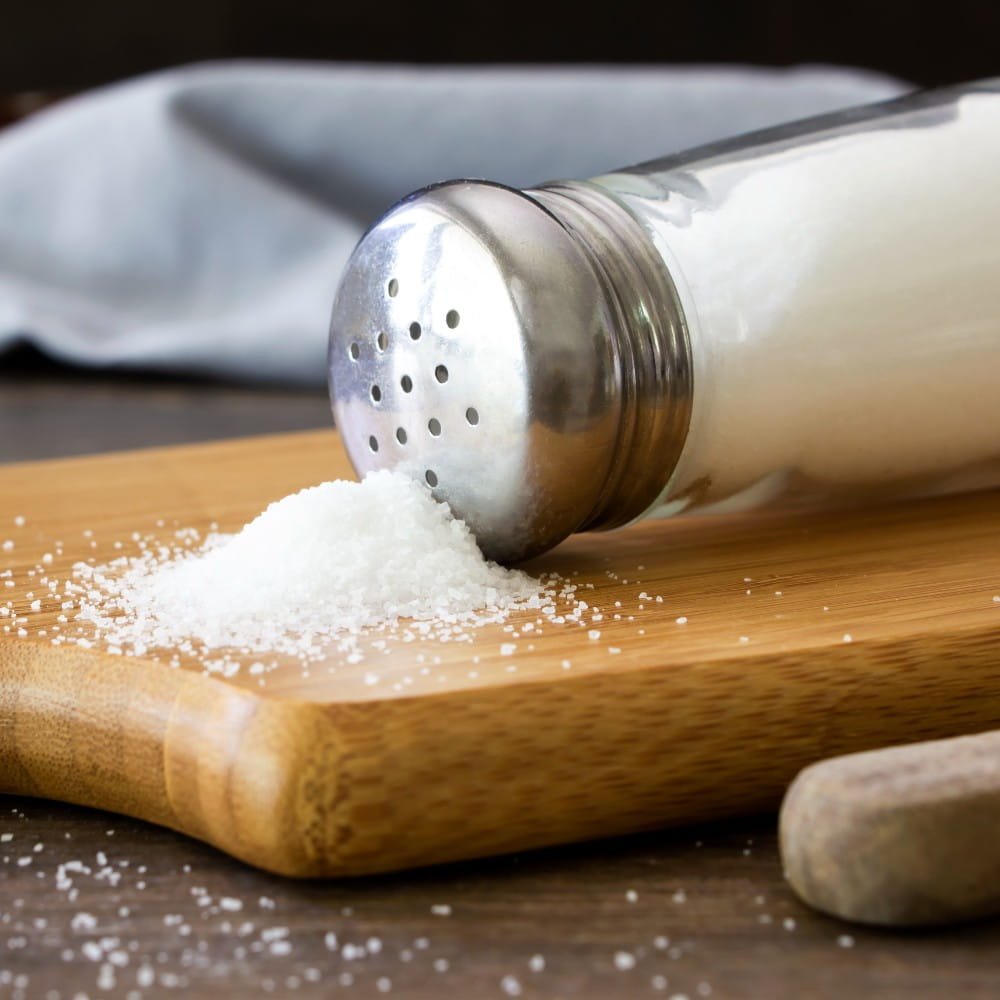 Salt on wooden chopping board. 