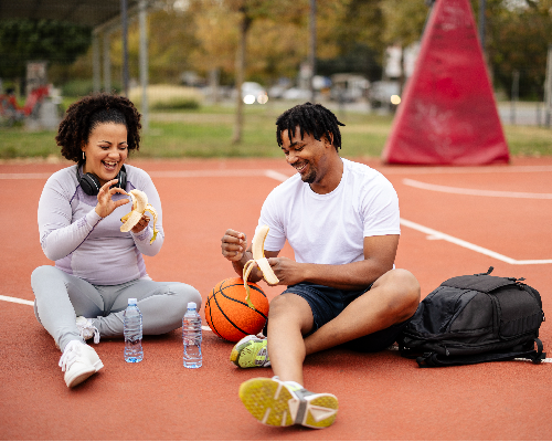Young african-american couple playing basketball