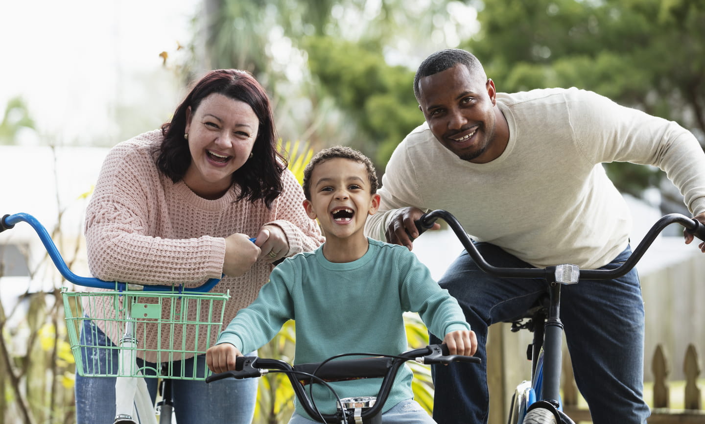 Boy and family getting ready to go on bike ride -