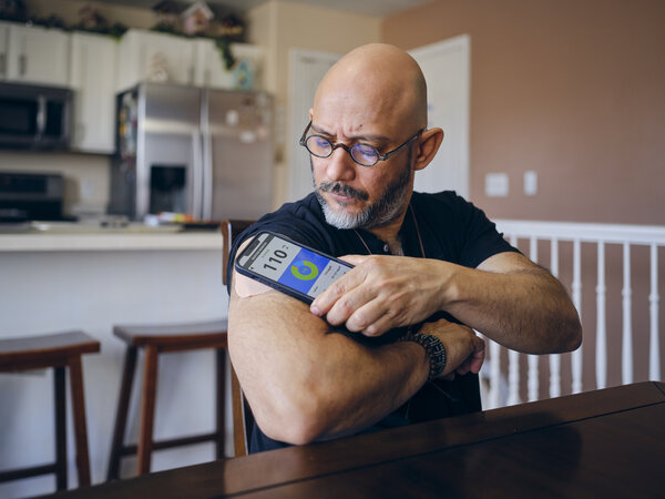 A Mature Man in a Home Checking His Blood Sugar 