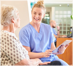 Healthcare worker talking with older woman