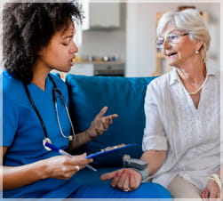 Healthcare worker taking womans blood pressure
