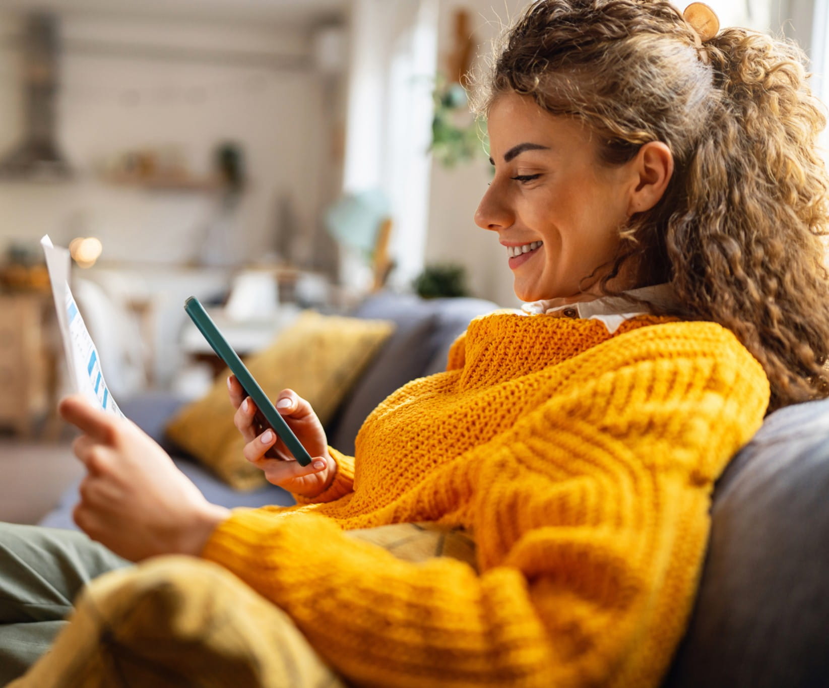 Side-view of an young Caucasian woman using smartphone for scanning the QR code and paying the bill